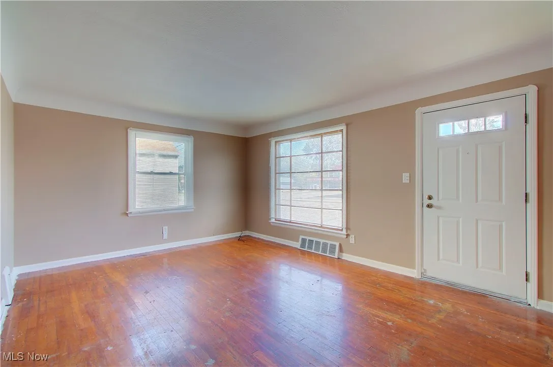 Foyer entrance featuring light wood finished floors and baseboards