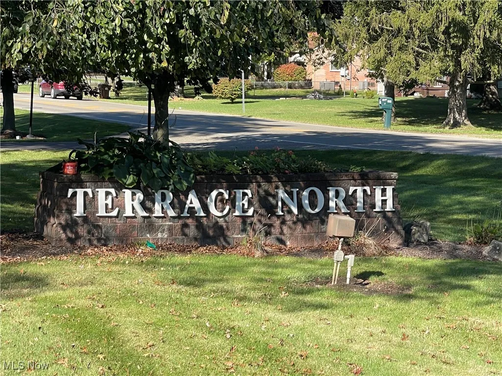 Community / neighborhood sign with a lawn