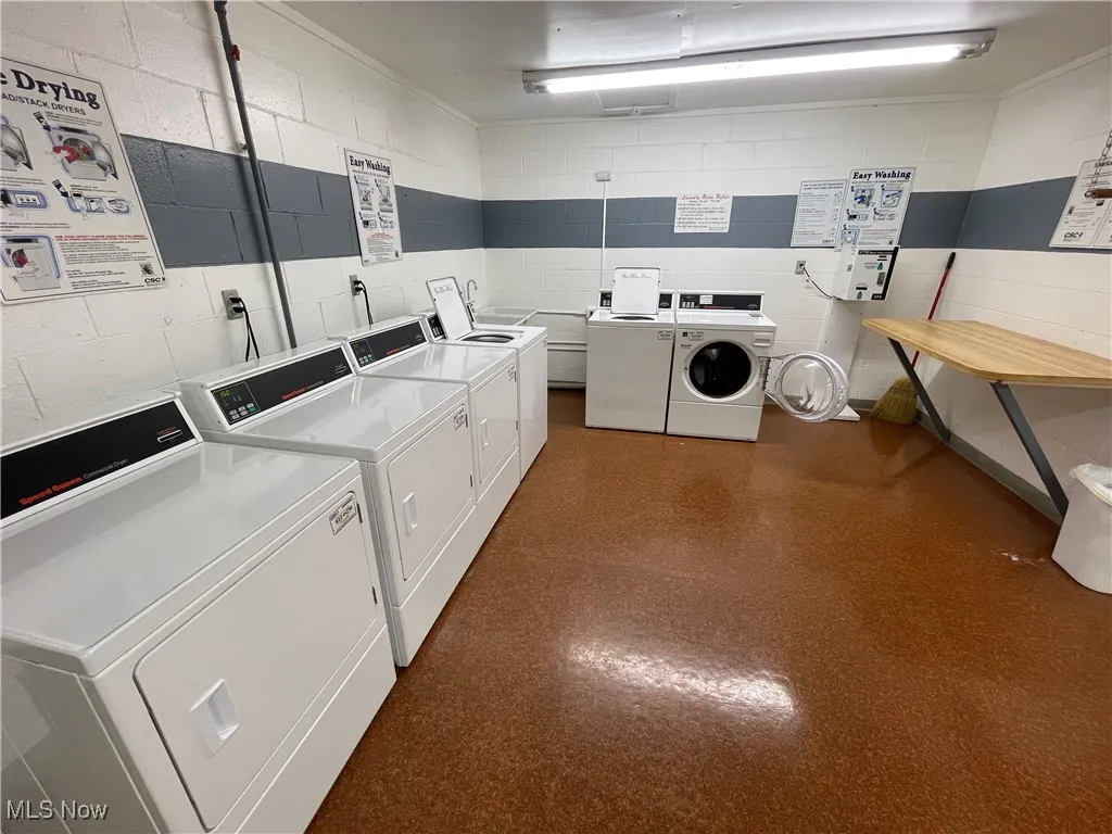 Community laundry room with washing machine and dryer