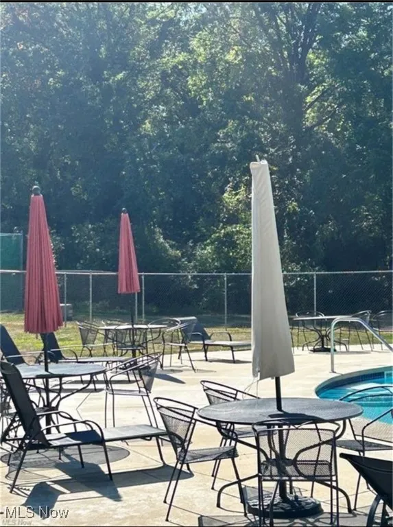 View of patio featuring a swimming pool and outdoor dining area