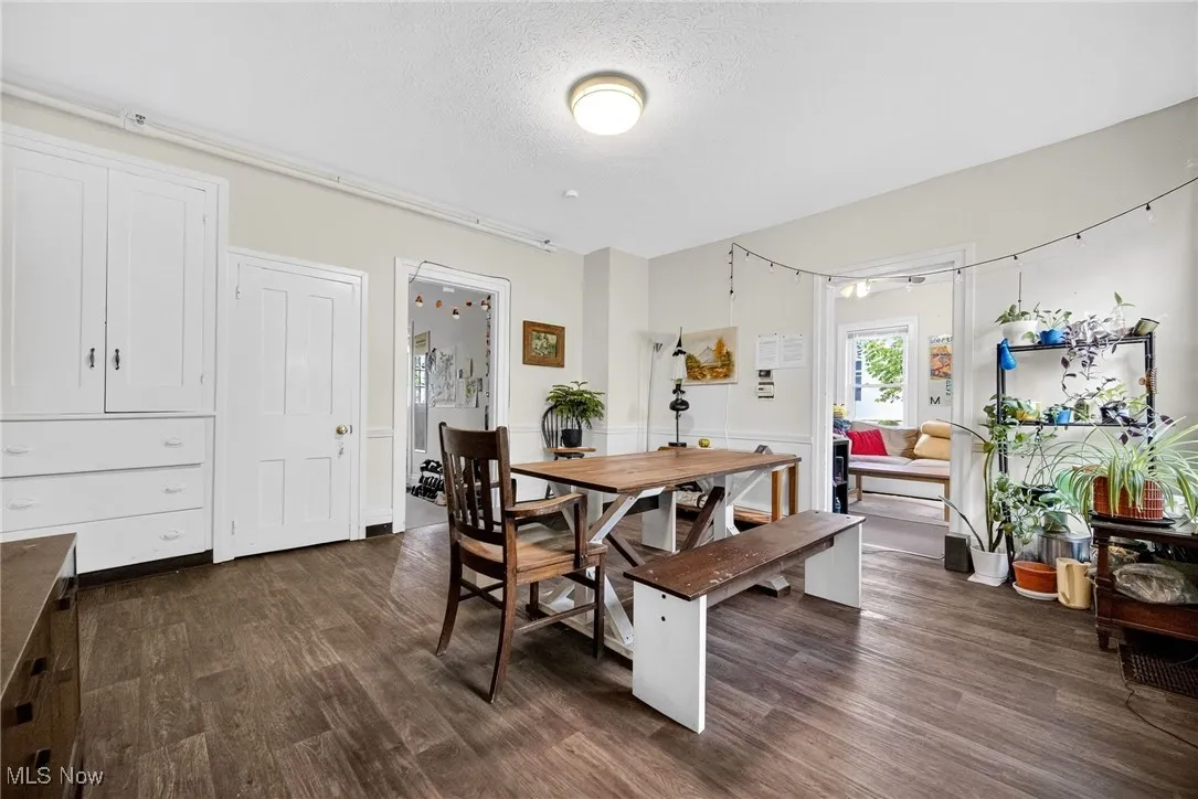 Dining space with dark wood-type flooring and a textured ceiling