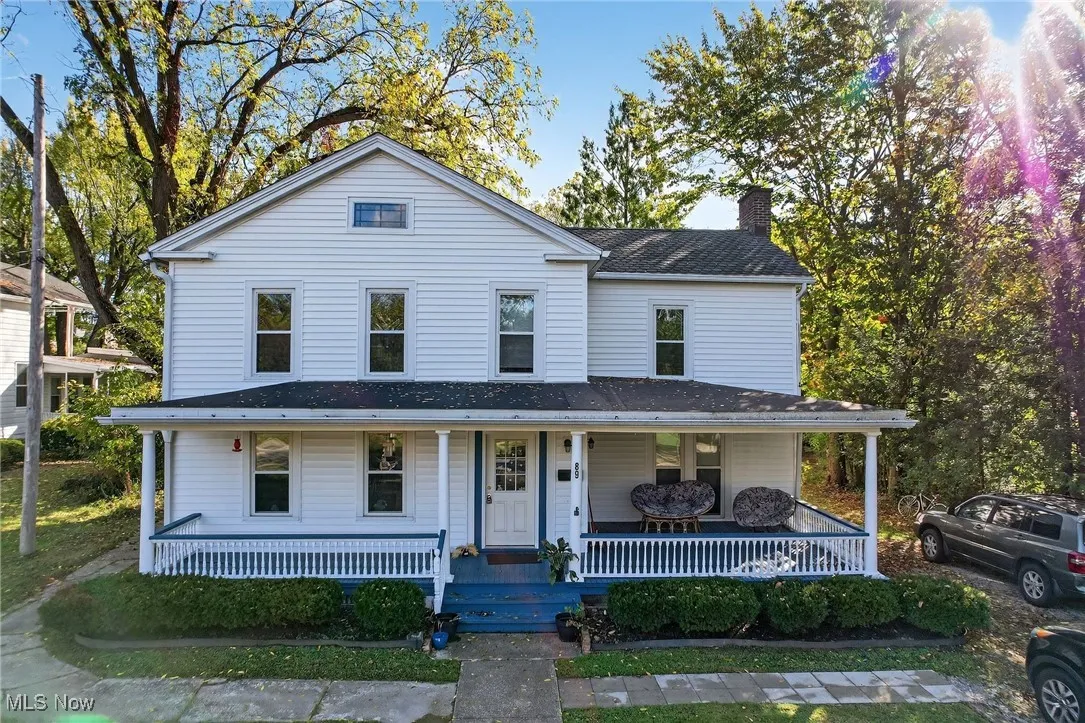 View of front of property with a porch and a chimney