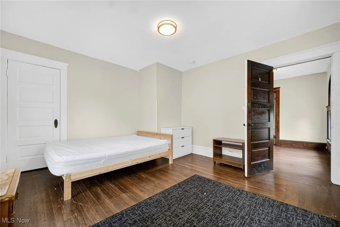 Bedroom featuring dark wood-type flooring
