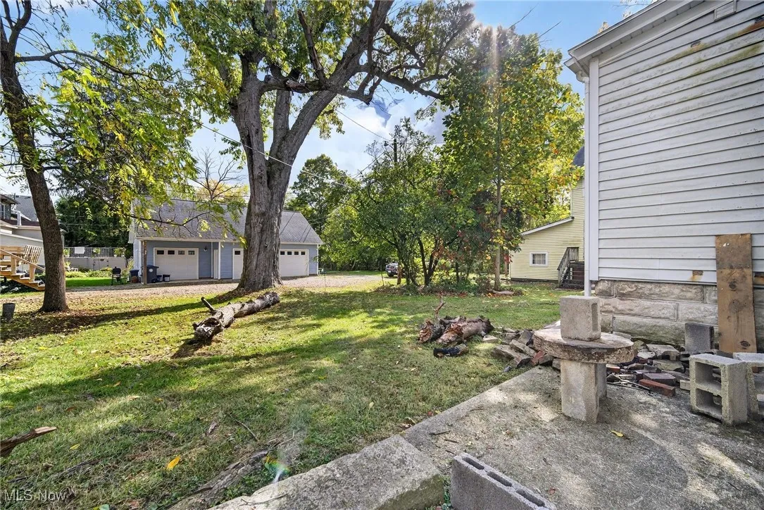View of green lawn with a garage