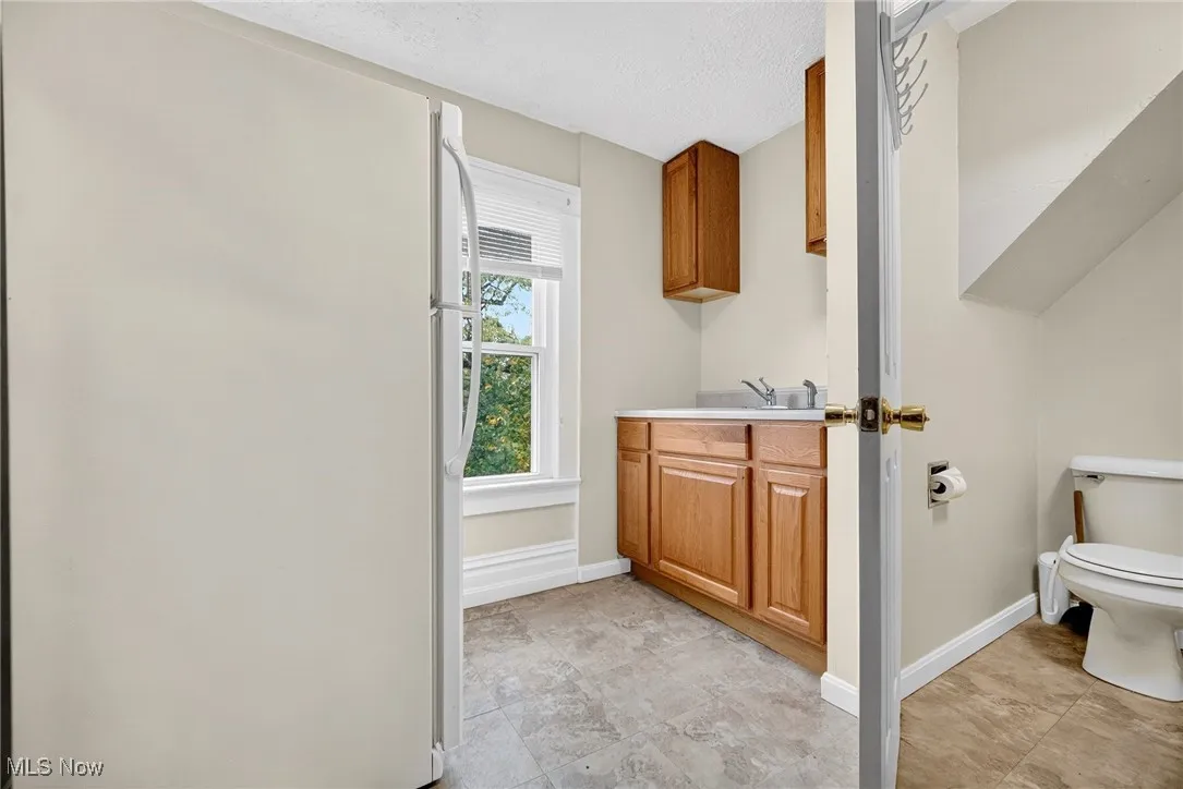 Bathroom with vanity and a textured ceiling