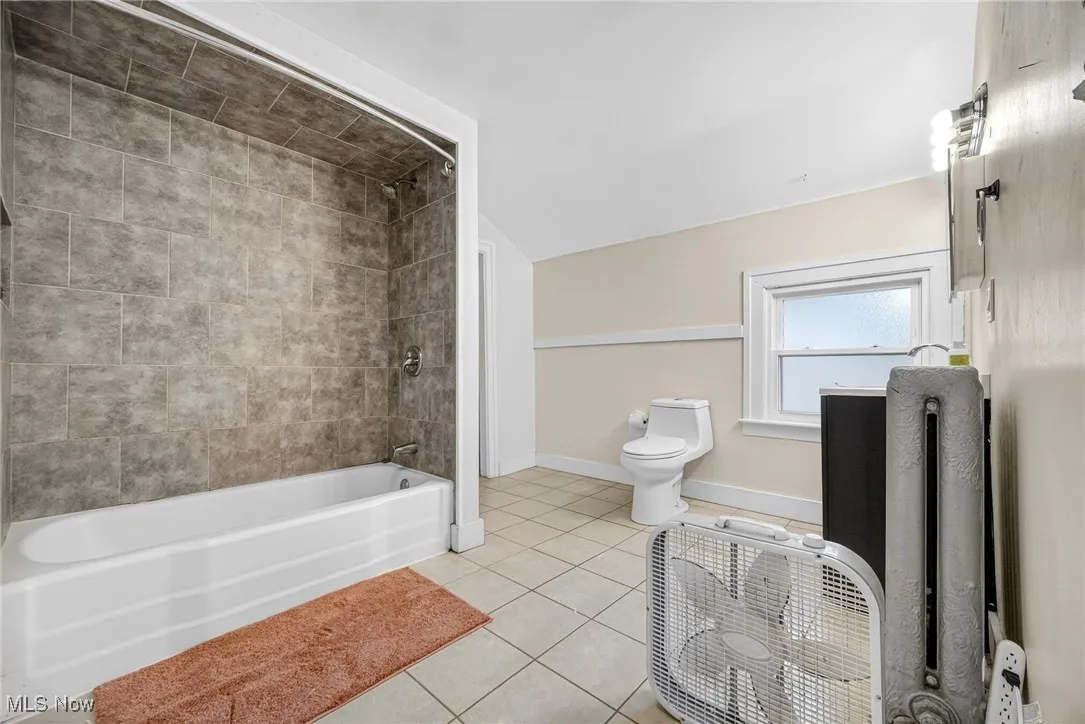 Full bath featuring bathtub / shower combination and tile patterned floors