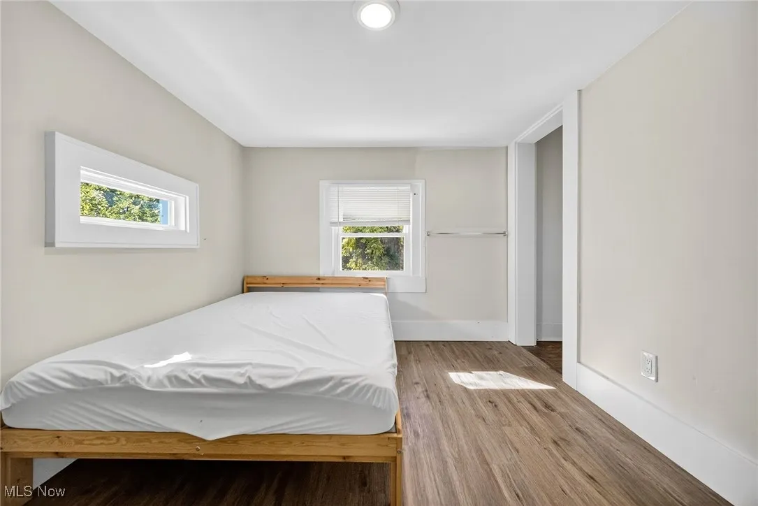 Bedroom featuring wood finished floors and baseboards