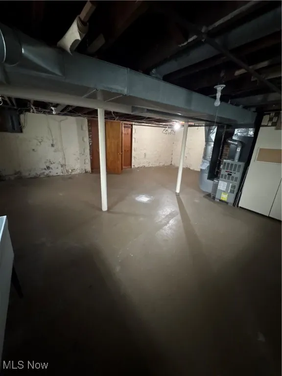 Unfinished basement featuring heating unit