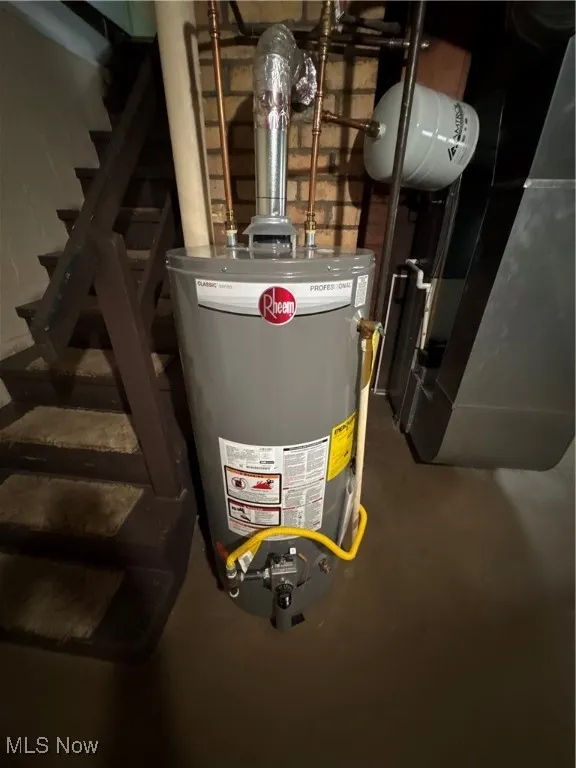 Utility room featuring water heater and heating unit