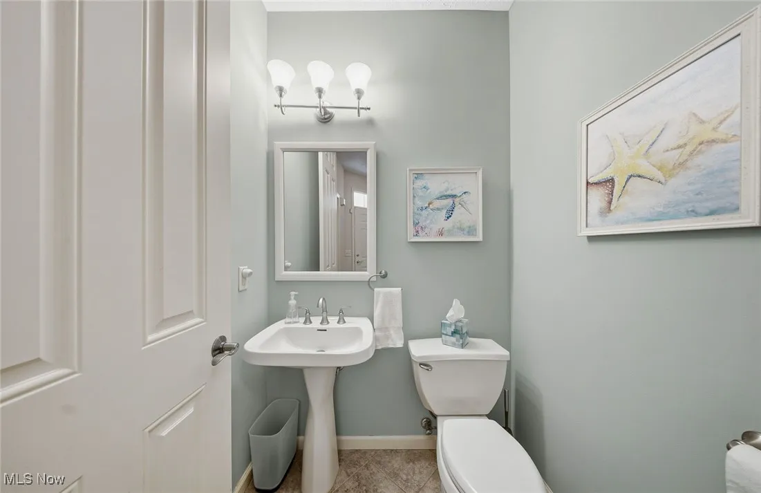 Bathroom with toilet and tile patterned flooring