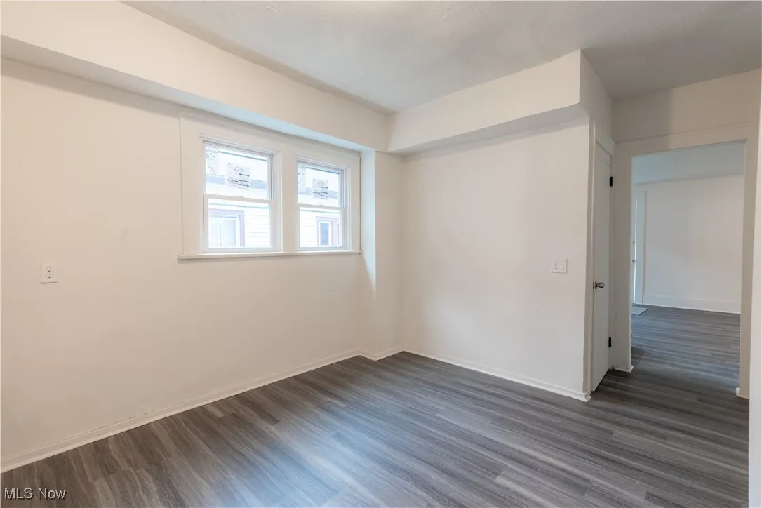Spare room with dark wood-style floors