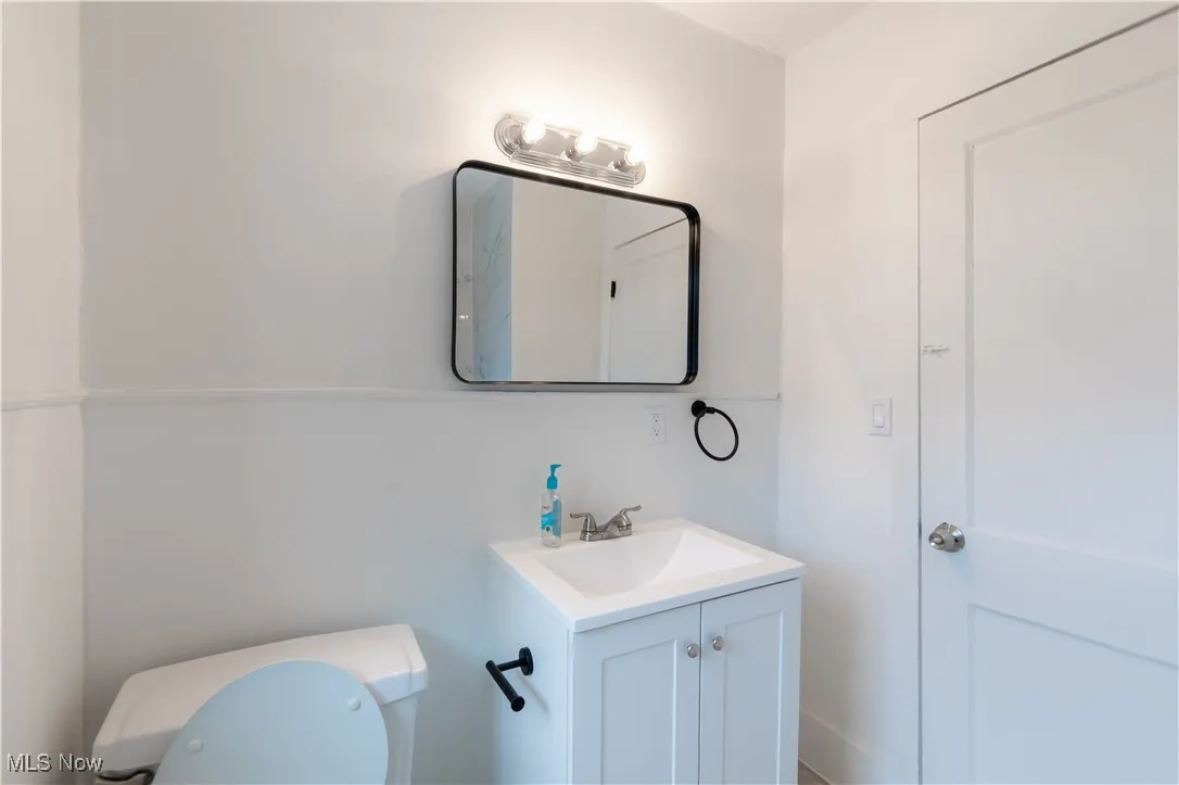 Half bath featuring toilet and vanity