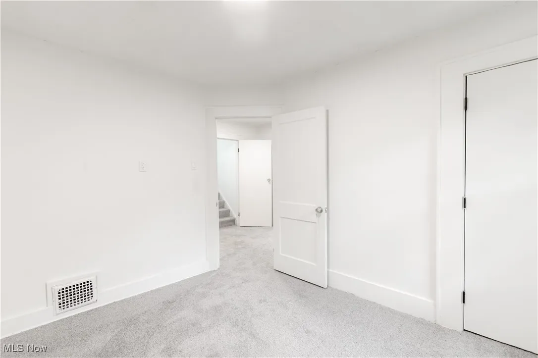 Unfurnished bedroom featuring carpet flooring and baseboards