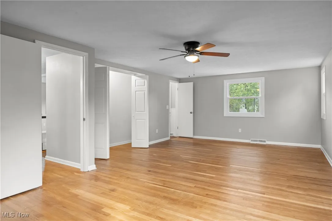 Unfurnished bedroom featuring light wood-type flooring and a ceiling fan