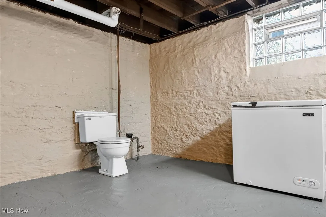 Bathroom featuring finished concrete flooring and toilet