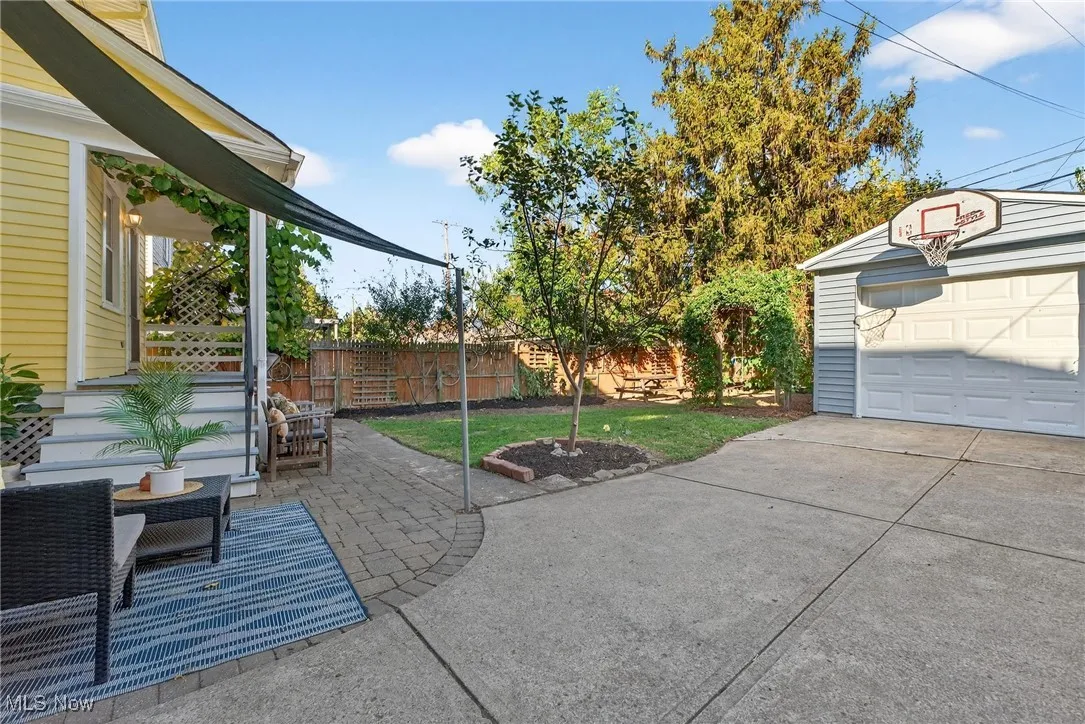 View of patio / terrace featuring an outbuilding and driveway