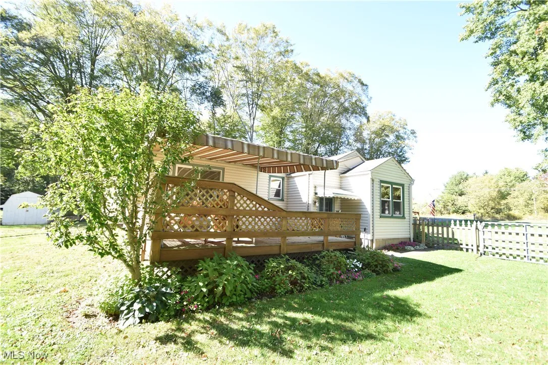 View of yard featuring a shed and a deck