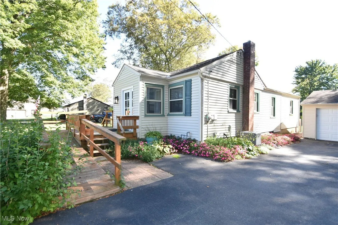 View of home's exterior with a chimney and an outdoor structure
