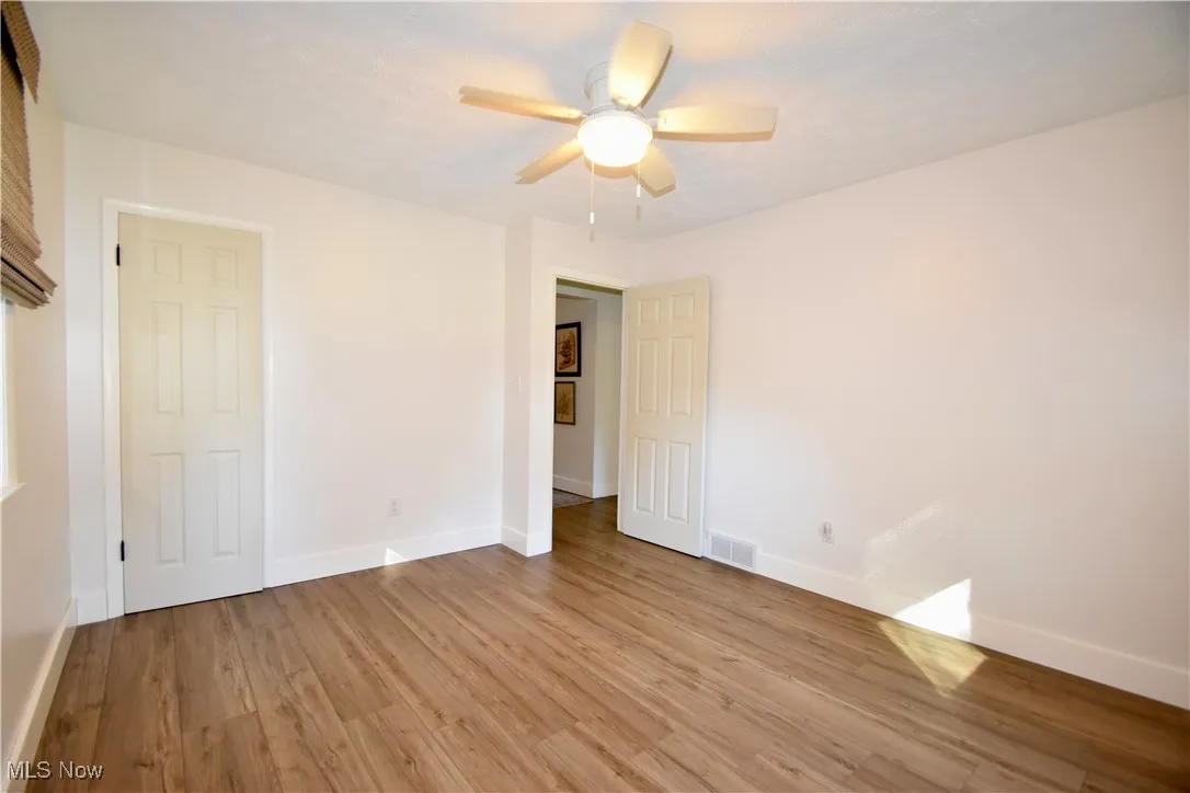 Unfurnished bedroom featuring light wood-style flooring and ceiling fan