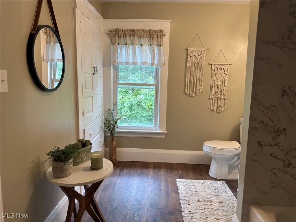 Bathroom with wood-type flooring and a tub