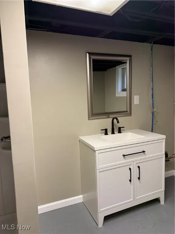 Bathroom with vanity and finished concrete flooring