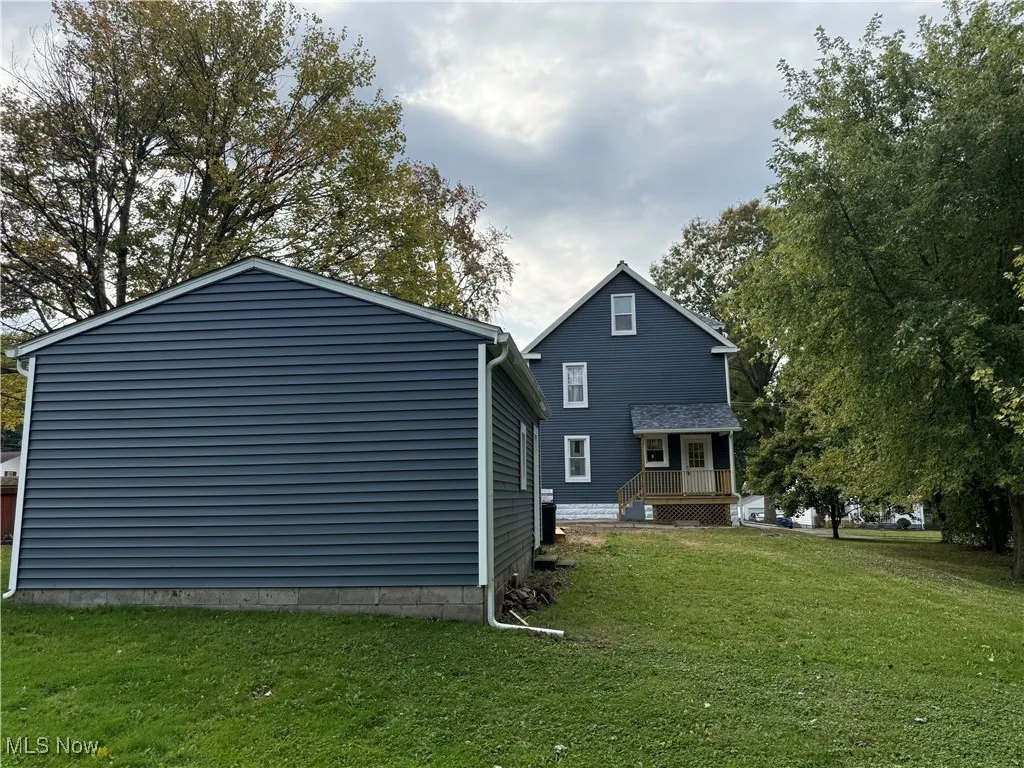 Rear view of house with a lawn