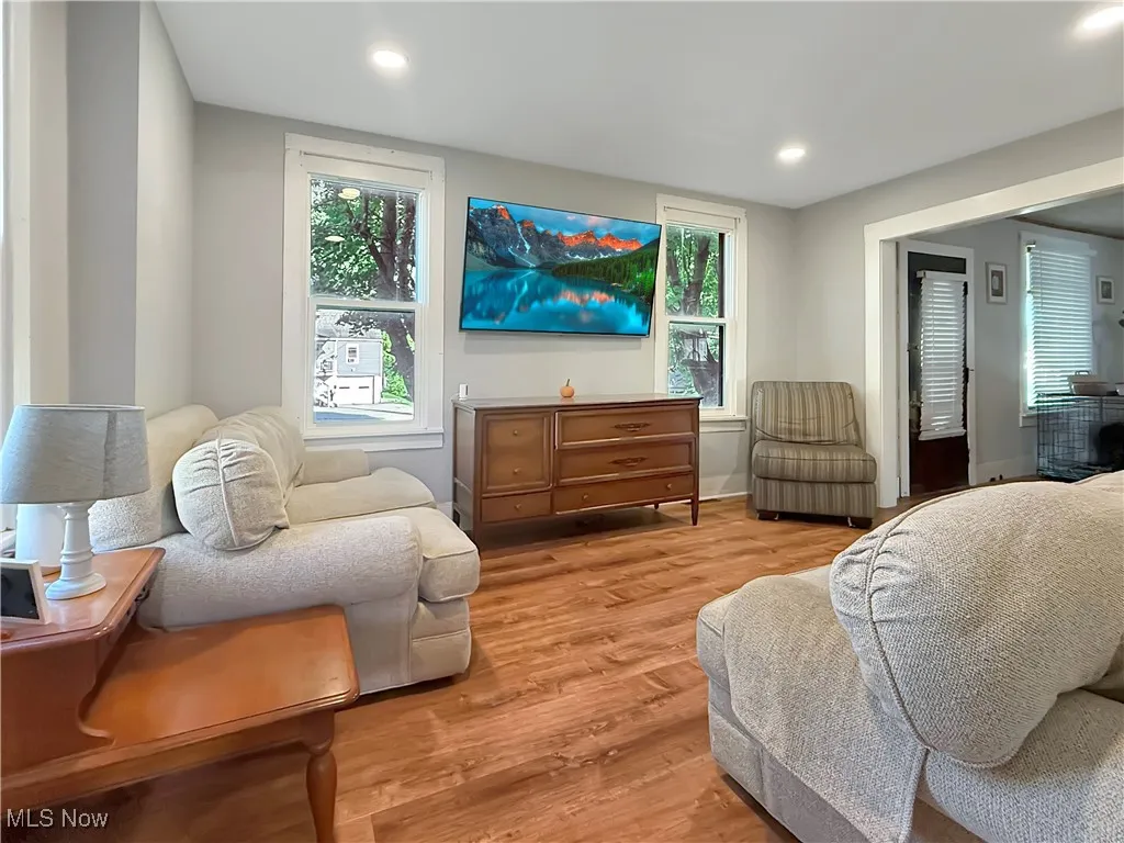 Living area featuring wood finished floors and recessed lighting