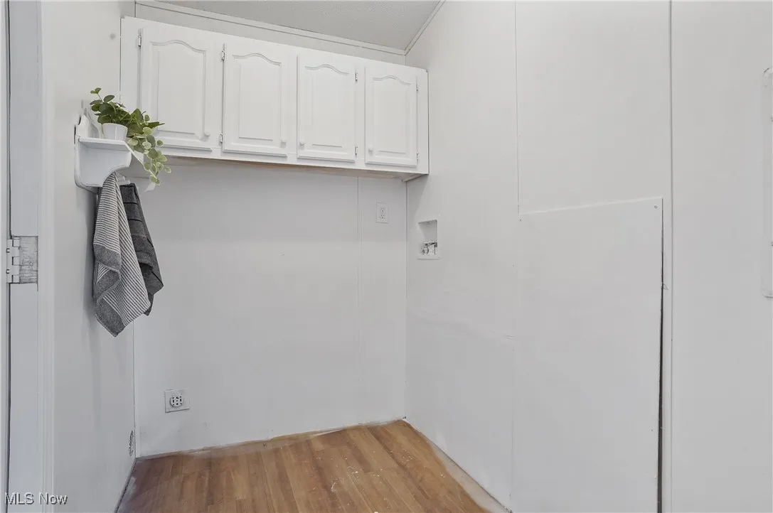 First floor laundry new 2025 paint and lighting. Newer flooring. Upper cabinets provides additional storage.