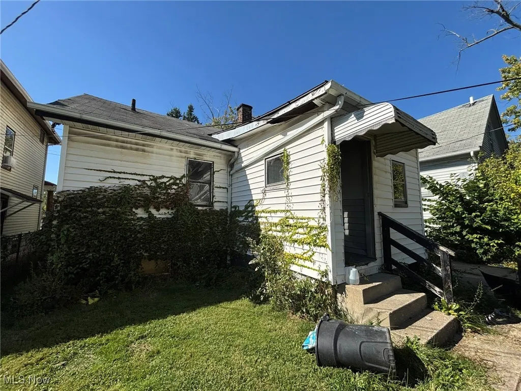 View of front of property with a front lawn and a chimney