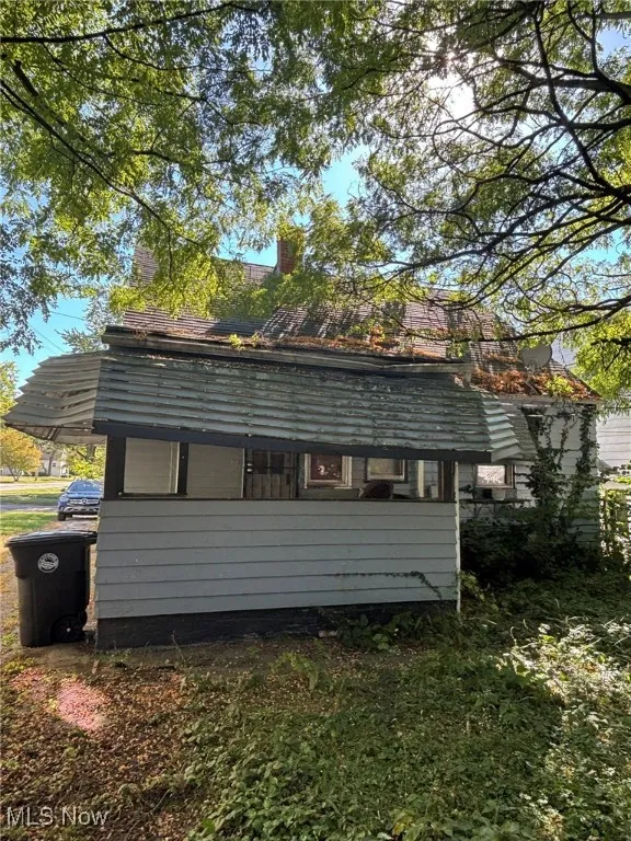 View of property exterior featuring a chimney