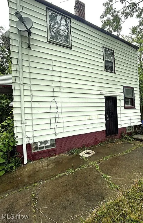 Rear view of property with a chimney
