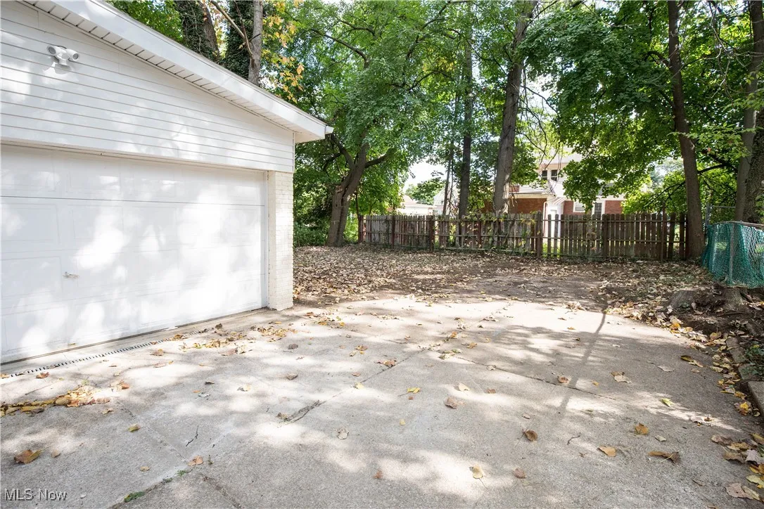 Garage featuring concrete driveway