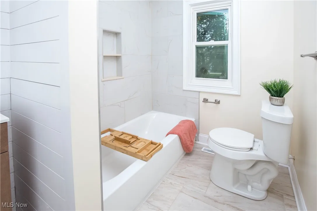 Bathroom featuring vanity and shower / bath combination