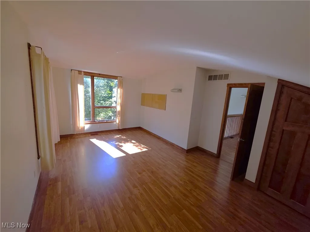 Unfurnished room with light wood-style flooring and baseboards
