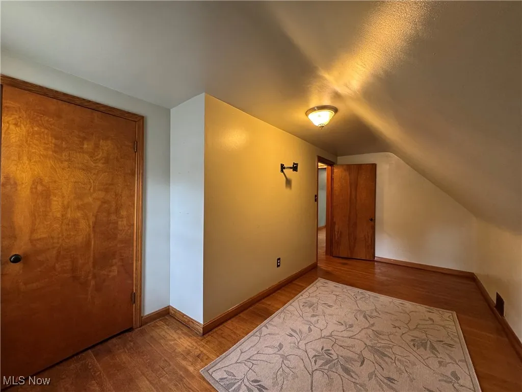 Bonus room featuring wood finished floors and lofted ceiling