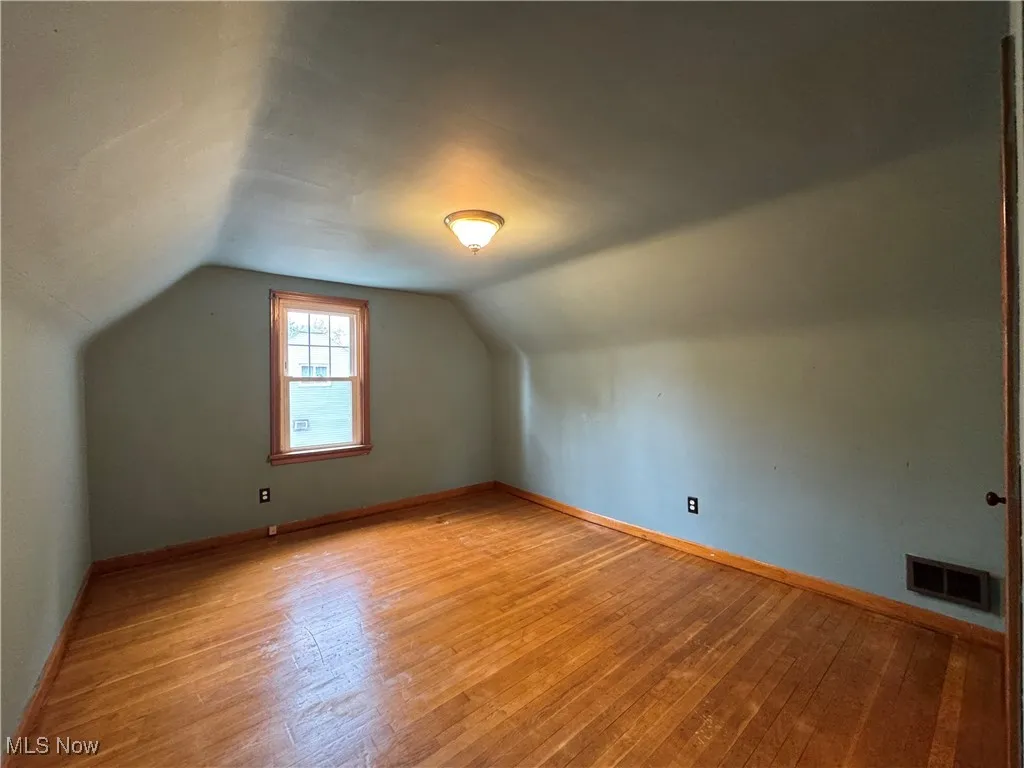 Bonus room featuring vaulted ceiling and hardwood / wood-style floors
