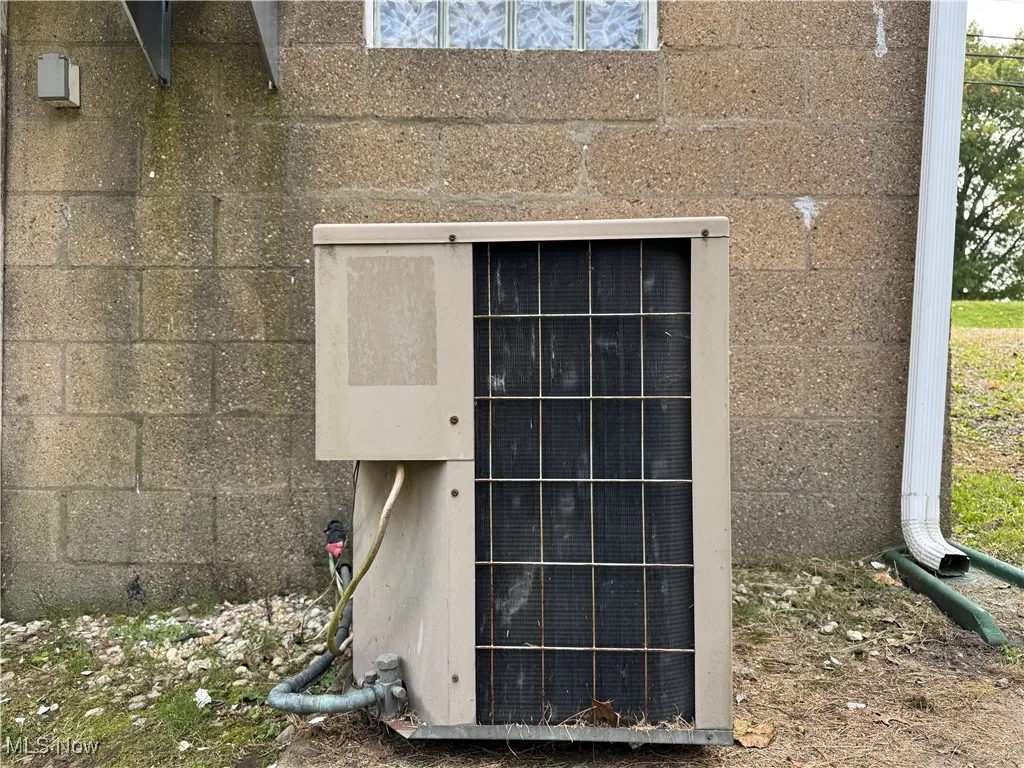 Exterior view of a cooling unit and concrete block siding