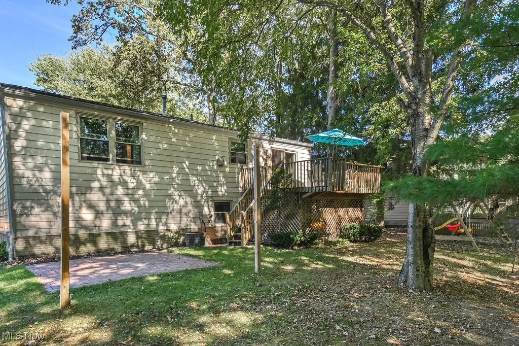 Back of property with stairway, a lawn, a deck, and a​​‌​​​​‌​​‌‌​‌‌​​​‌‌​‌​‌​‌​​​‌​​ patio