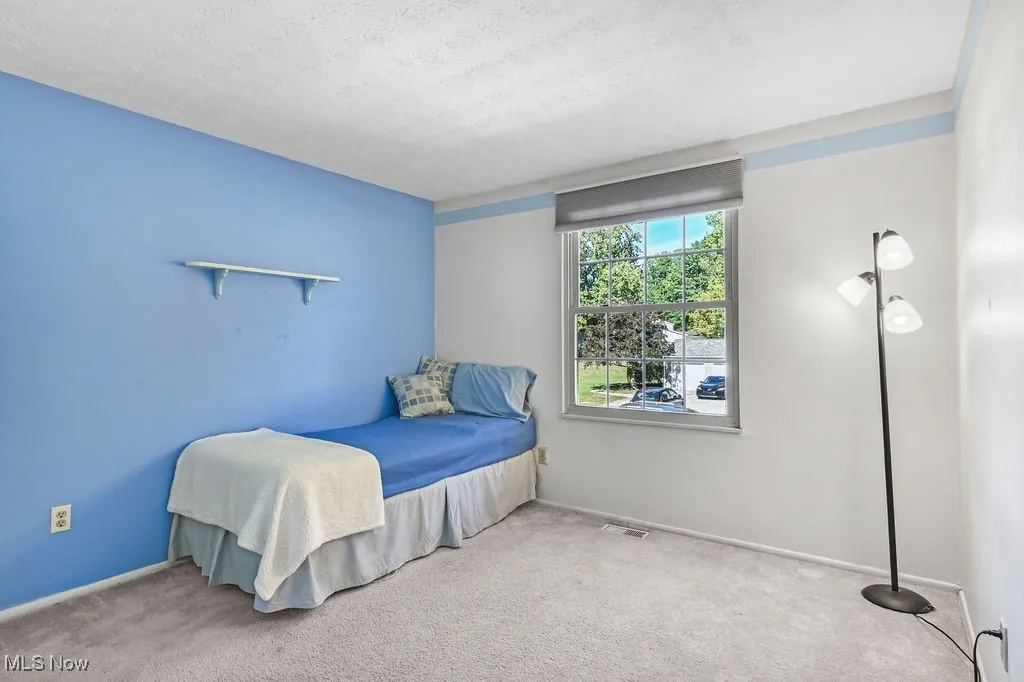 Bedroom featuring carpet flooring and a textured ceiling