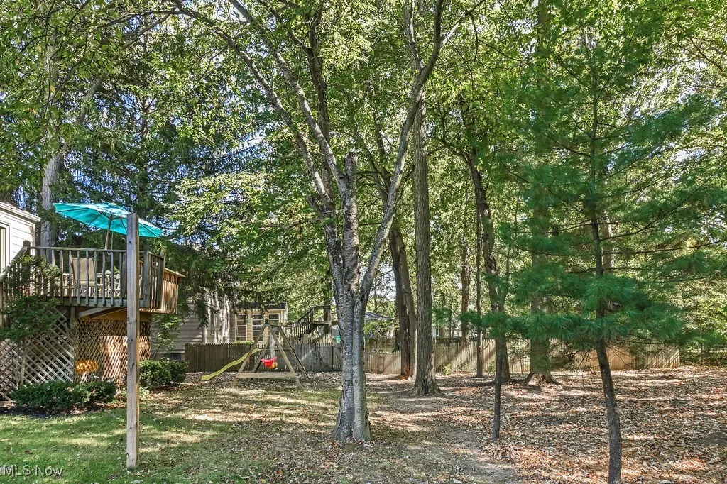 View of yard featuring a playground and a deck