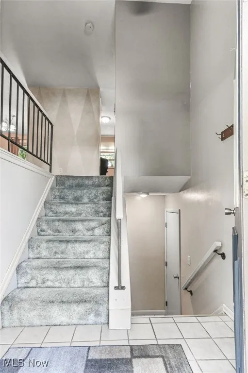 Stairway featuring tile patterned floors
