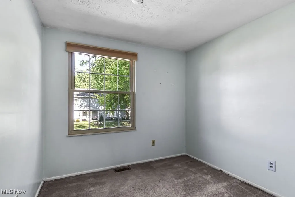 Bedroom featuring carpet and a textured ceiling