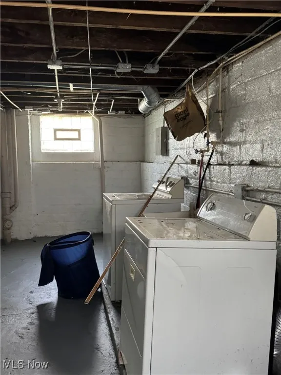 Laundry room with unfinished concrete floors and independent washer and dryer