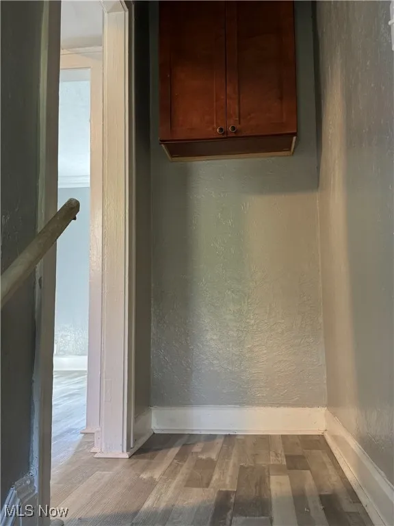 Detailed view of a textured wall and wood finished floors