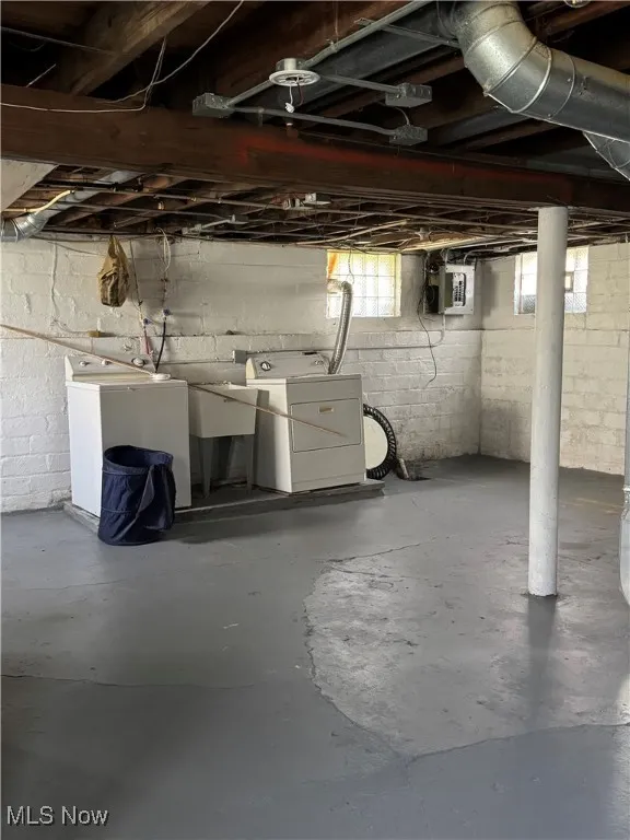 Below grade area featuring independent washer and dryer and electric panel