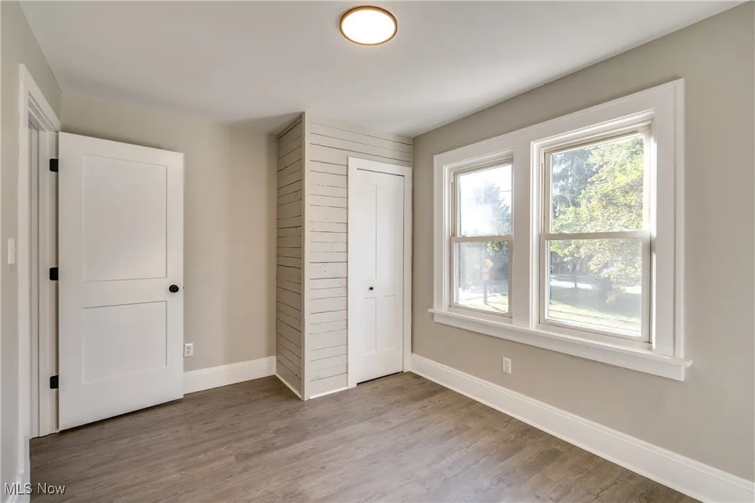 Unfurnished bedroom featuring light wood-style flooring and a closet