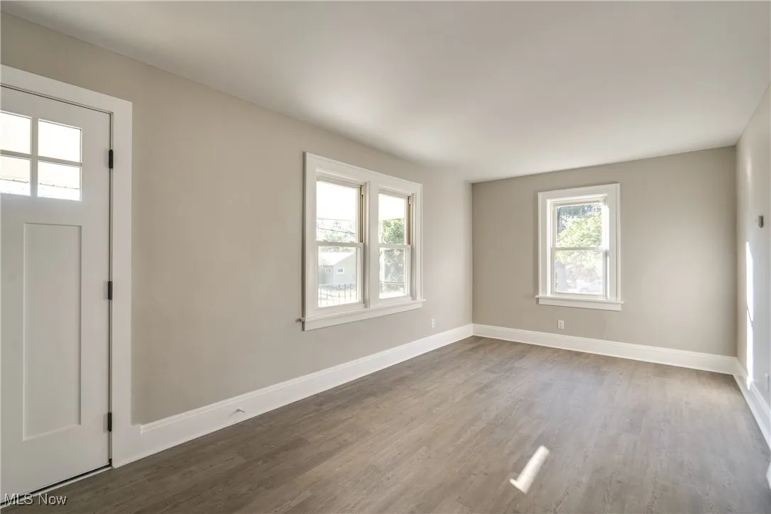 Entryway featuring baseboards and wood finished floors