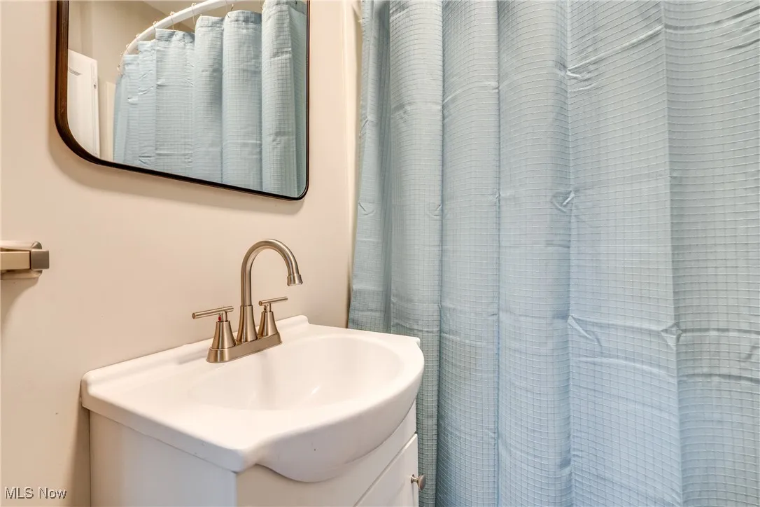 Full bath featuring vanity and a shower with shower curtain