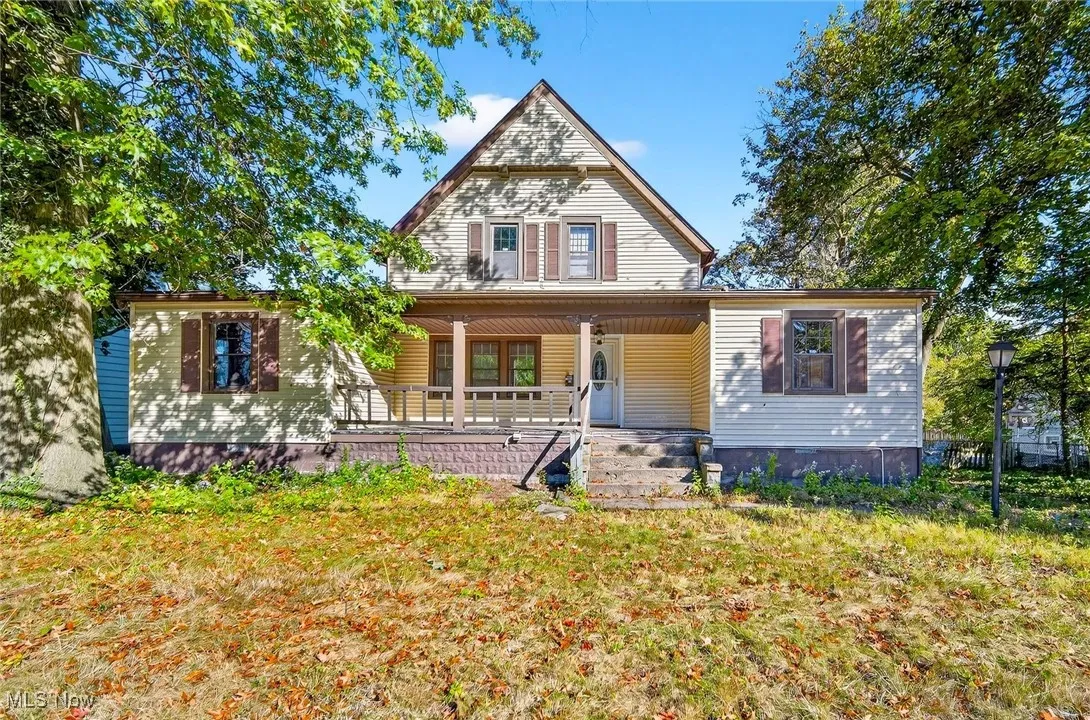 View of front of house with a porch and a front lawn