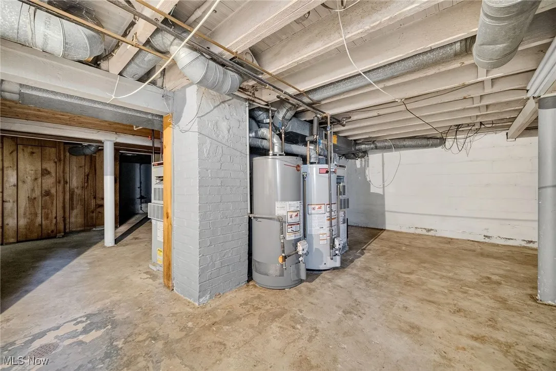 Unfinished basement featuring water heater